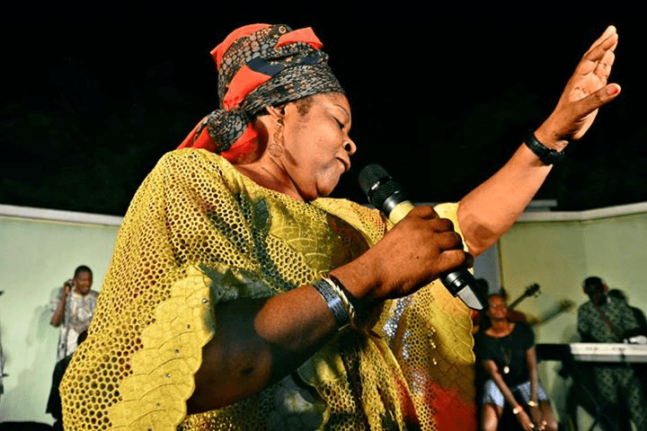 On stage, microphone raised